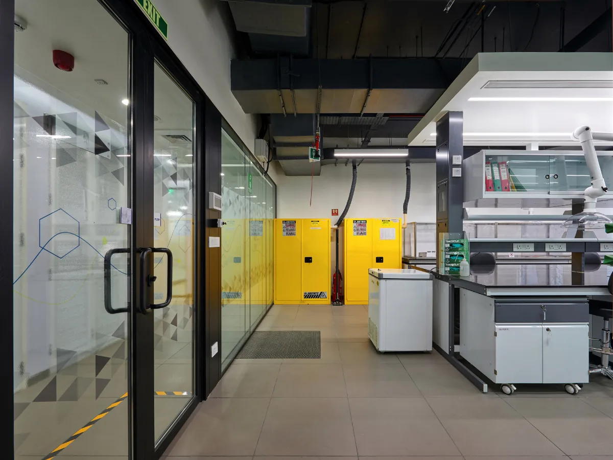 Yellow Justrite flammable safety cabinets at lab entrance