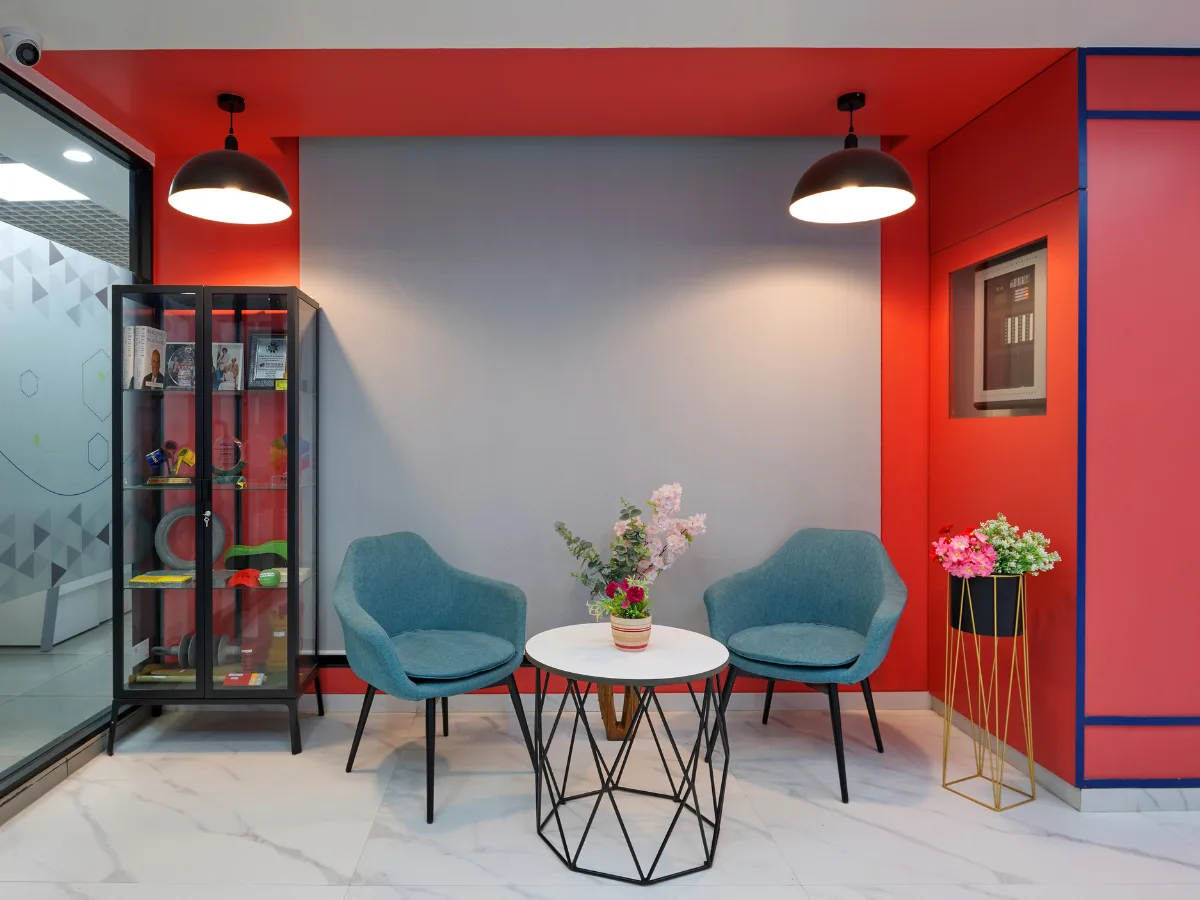 Seating nook with teal chairs and product display cabinet