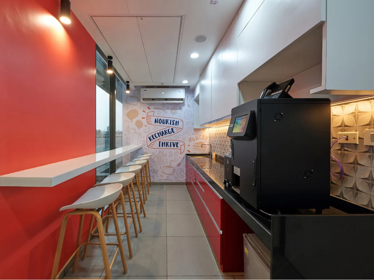 Pantry with bar stools, coffee machine and motivational wall graphic