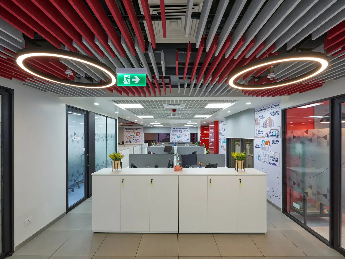 Open-plan workstations with acoustic ceiling baffles and ring pendants