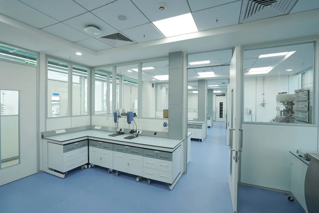 Formulation suite with homogenisers and view into tablet-press room