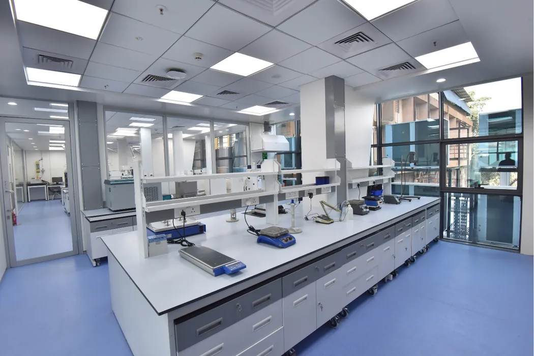 Laboratory island bench with reagent shelf and analytical instruments