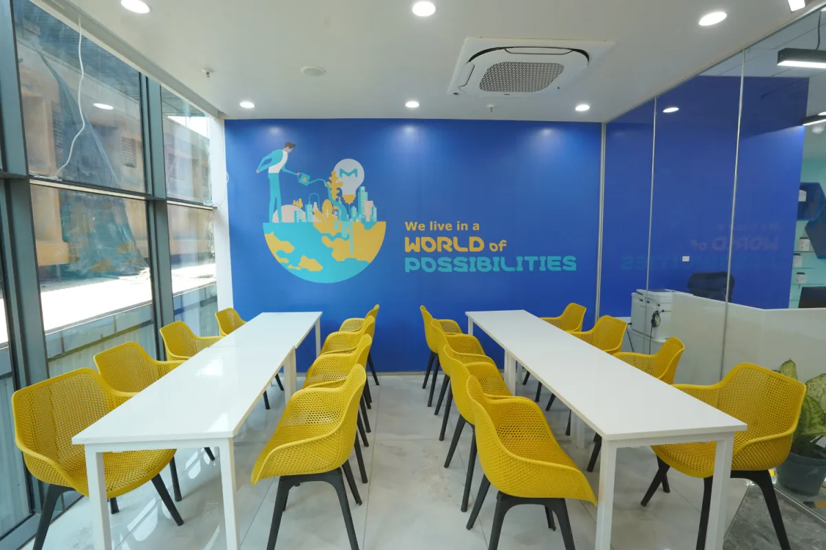 Cafeteria with yellow chairs and World of Possibilities mural