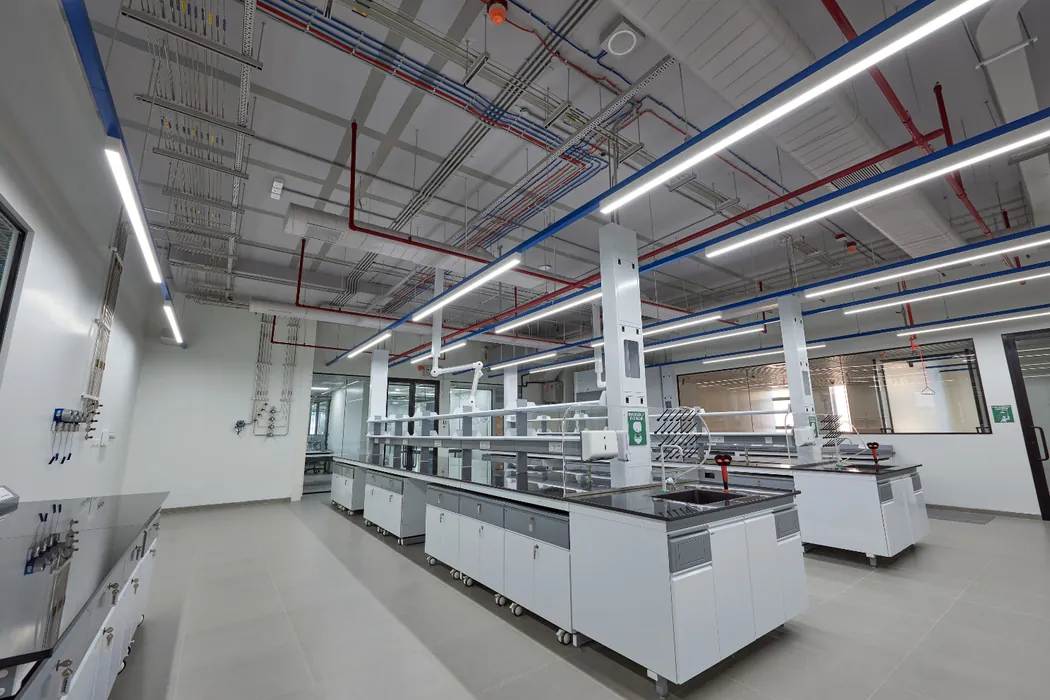 Laboratory island benches with overhead extractors and gas service lines