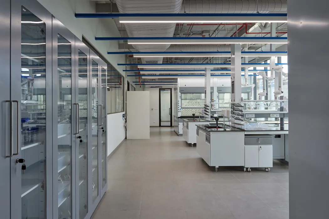 Laboratory with tall glass storage cabinets and fume hoods