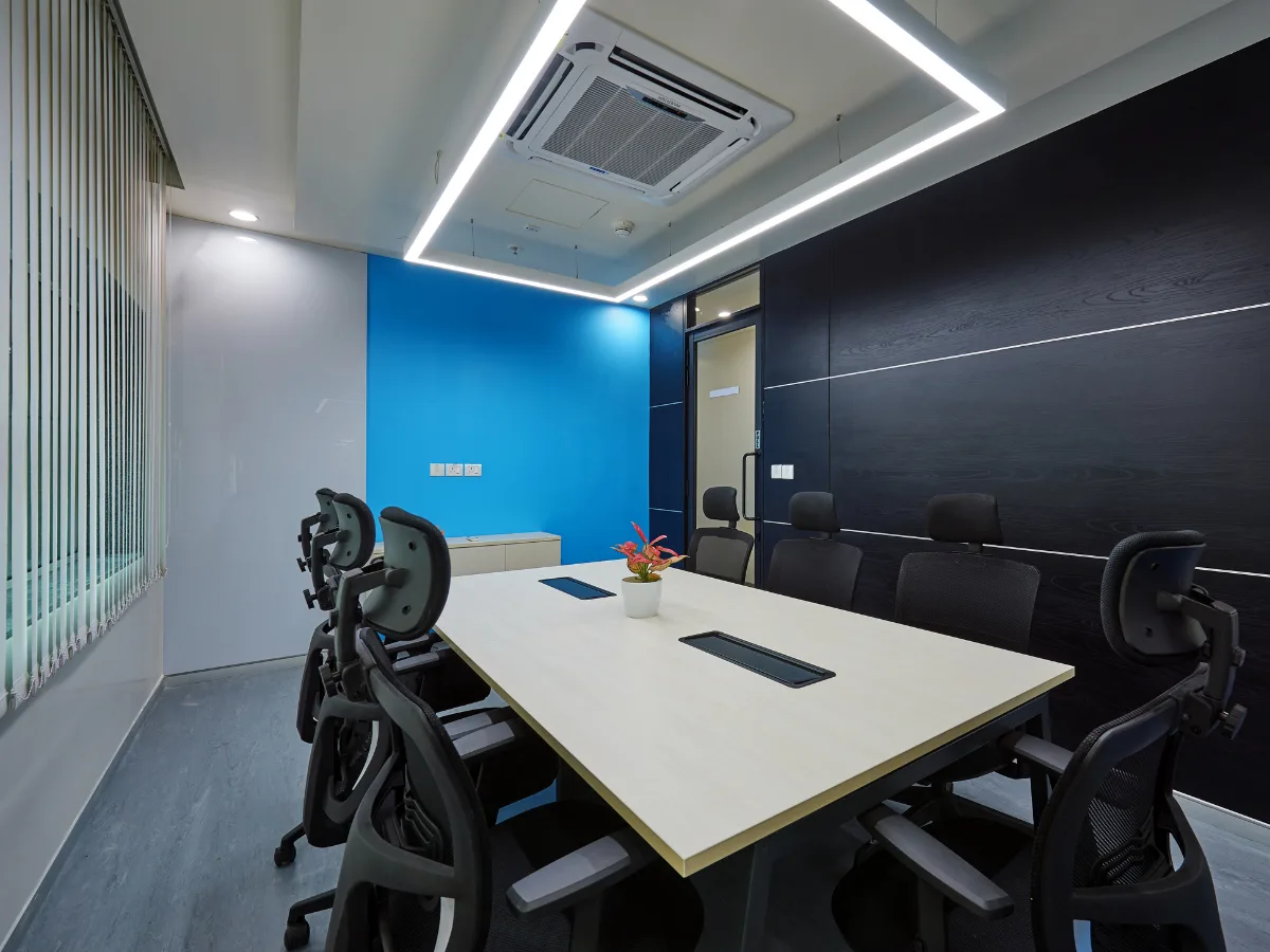Conference room with dark wood wall and rectangular LED ceiling light