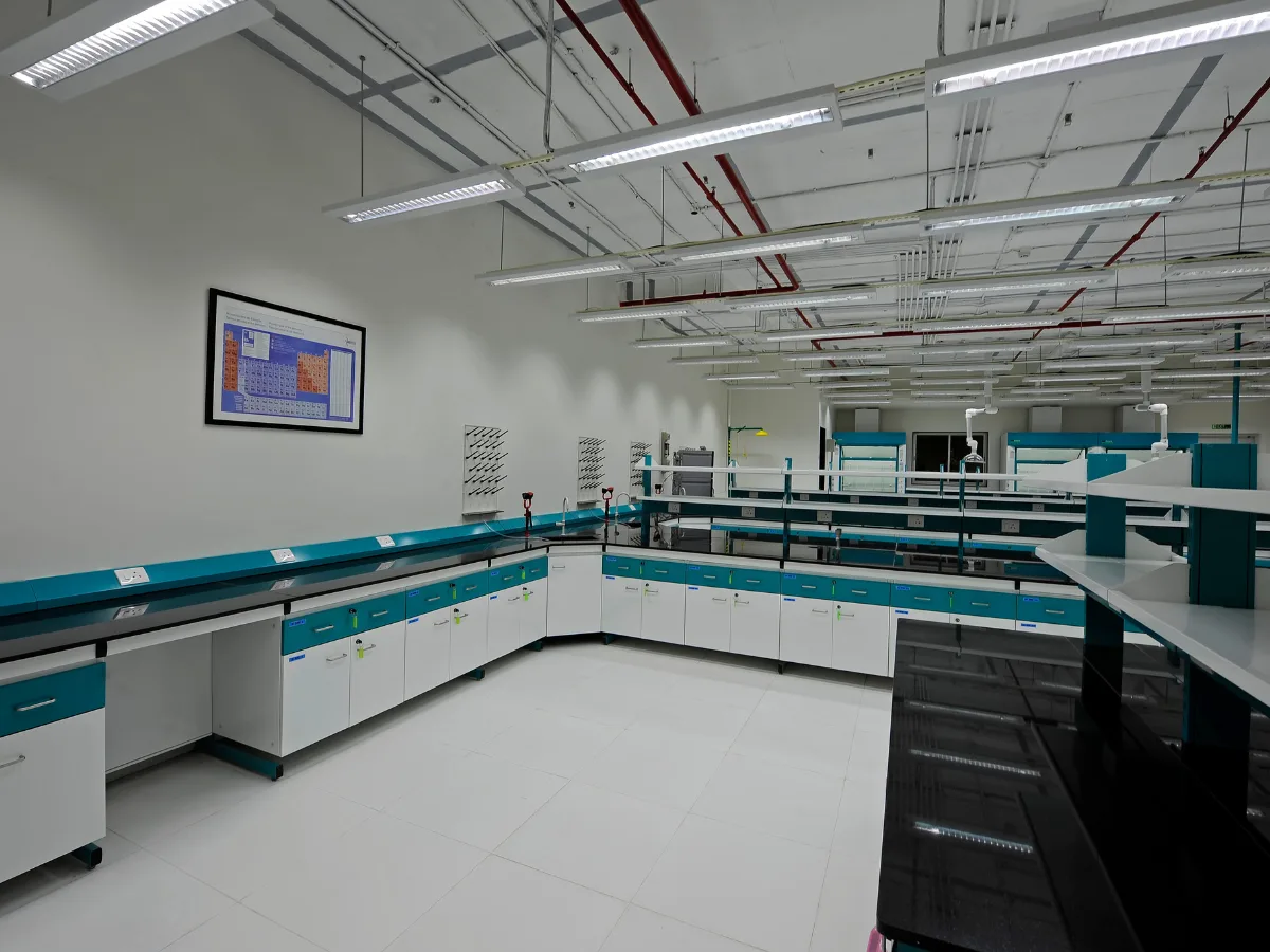 L-shaped benches with periodic table poster and pegboard drying racks