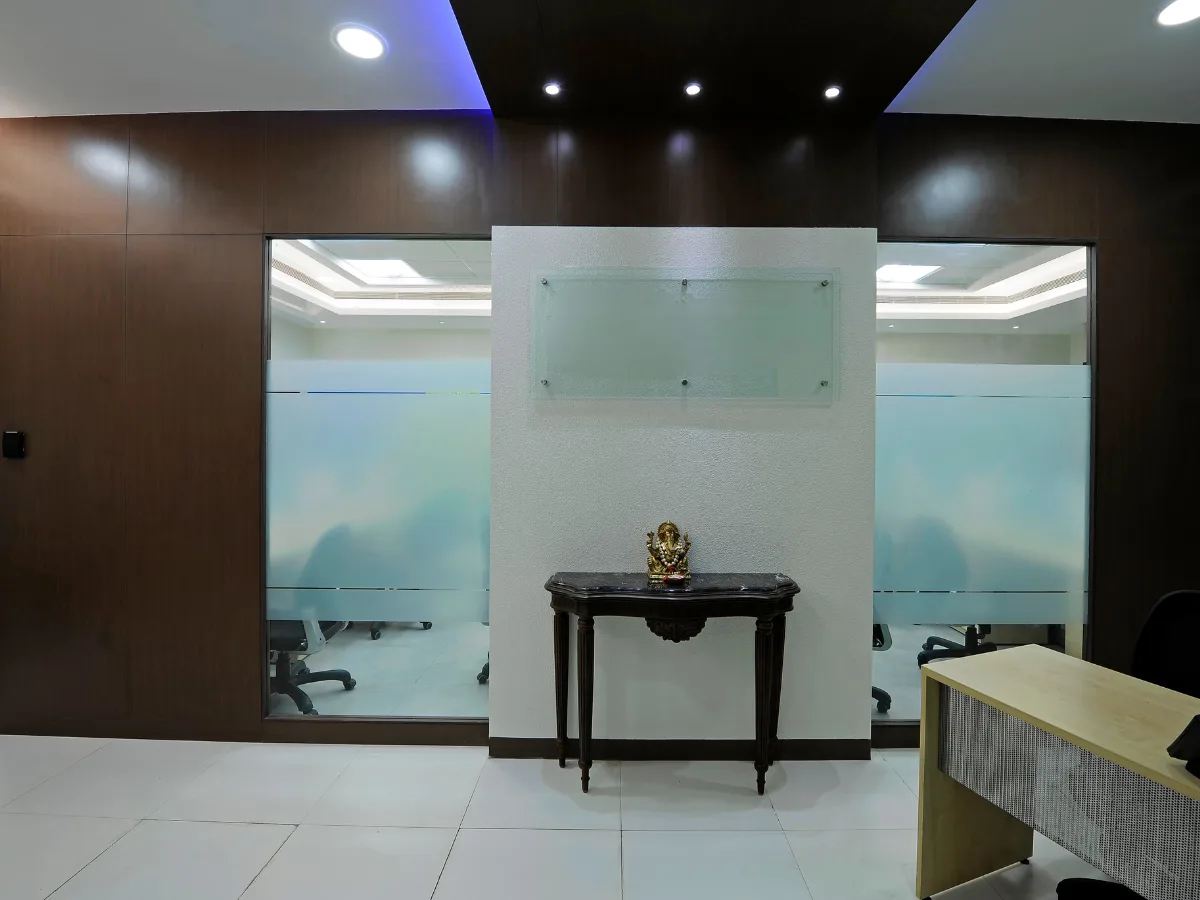 Reception with dark wood paneling and frosted glass partitions