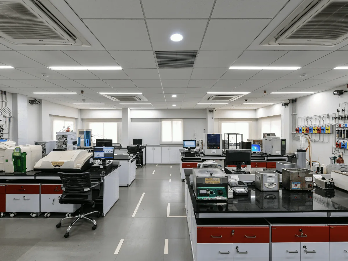 Analytical lab with red modular benches, instruments and gas regulator panels
