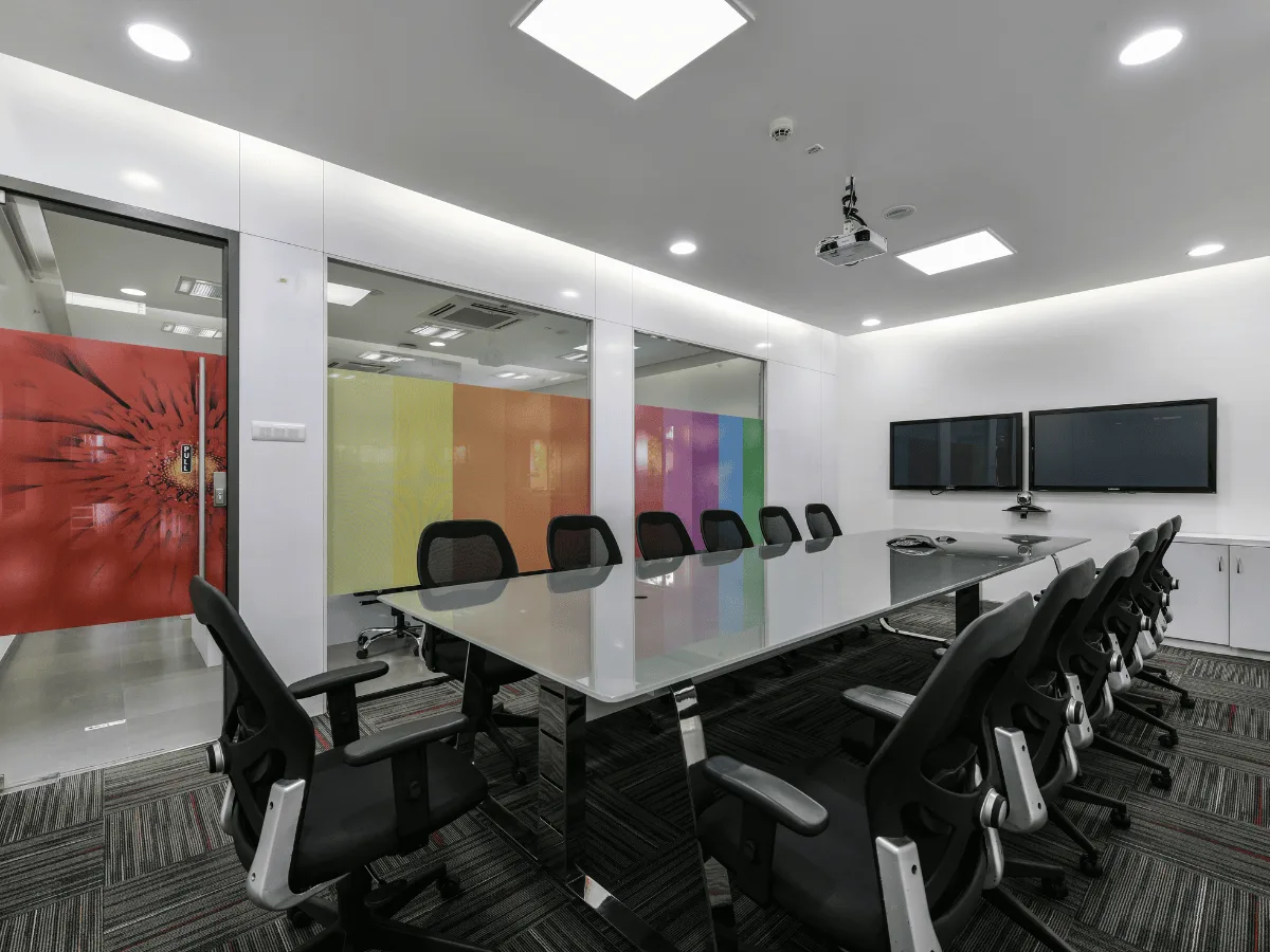 Conference room with rainbow gradient glass partition and dual monitors