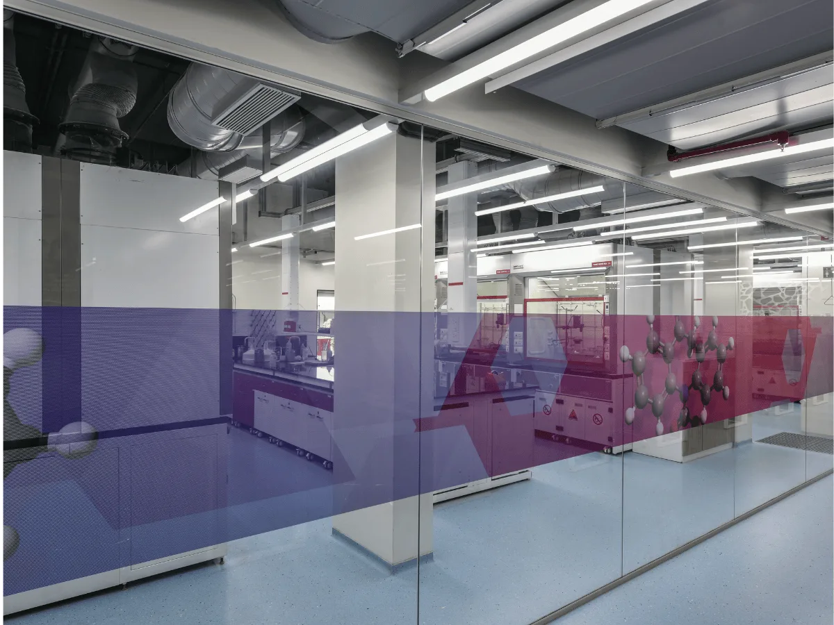 Glass corridor with molecule graphics looking into lab