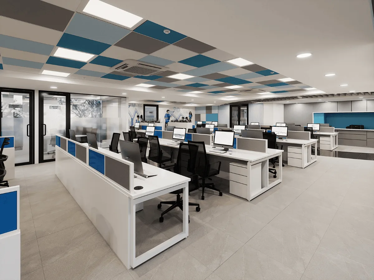 Open-plan workstations with checkered ceiling panels and monitors