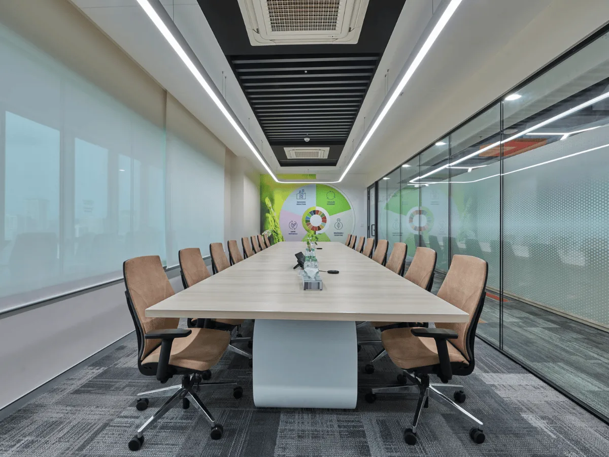 Conference room with tan chairs and sustainability wall graphic