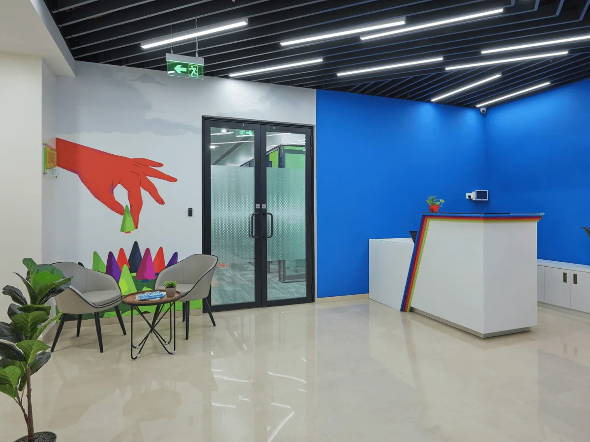 Lobby with colourful hand mural and rainbow-edge reception desk