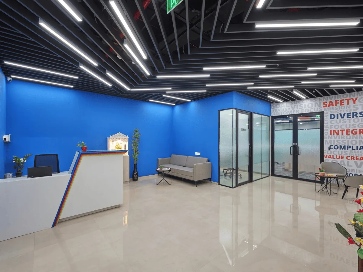 Reception with blue accent wall and linear ceiling lights