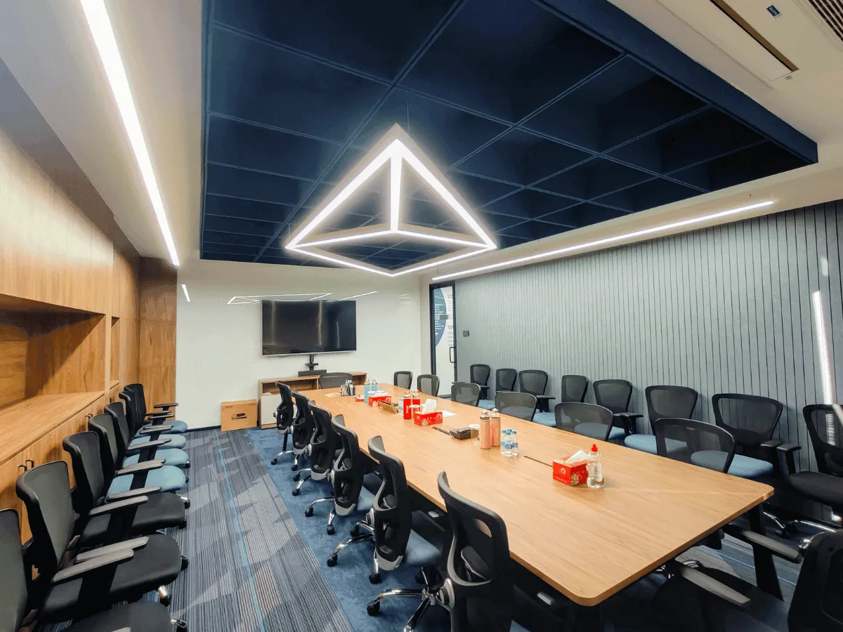 Conference room with geometric LED pendant and oak boardroom table