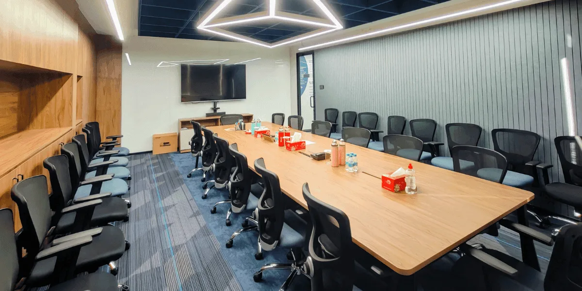 Corporate office conference room with geometric pendant light in Thane