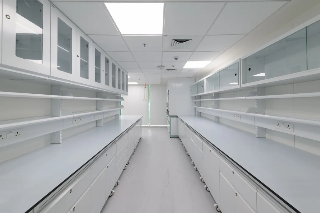 Prep laboratory with mobile benches and glass-fronted wall cabinets