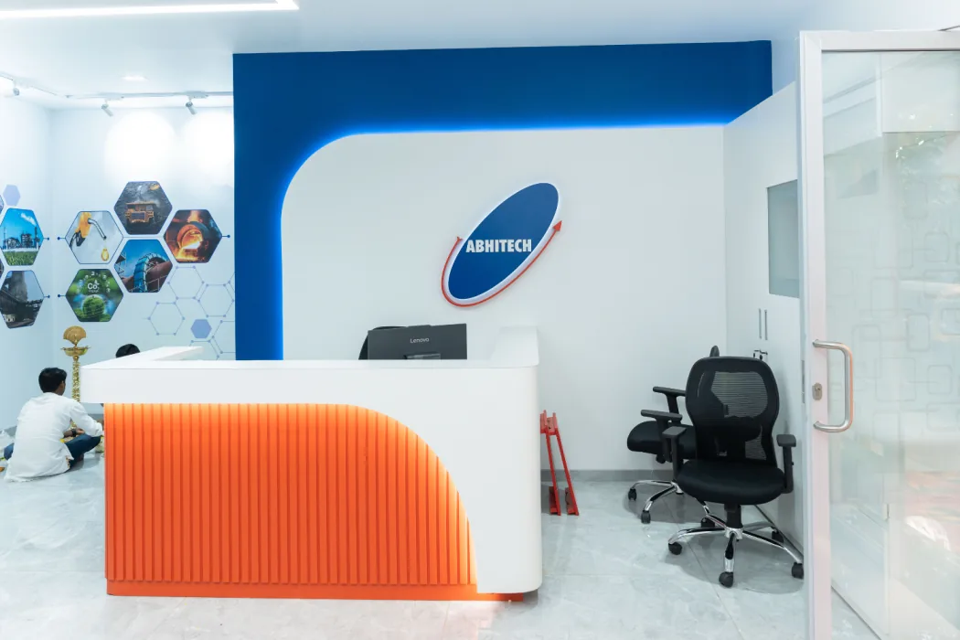 Reception with orange desk and decarbonisation-themed hexagon wall graphics