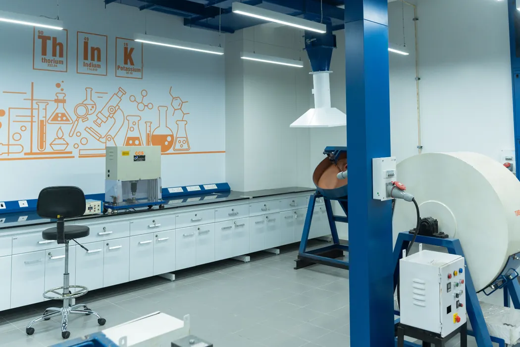 Testing lab with milling equipment and periodic-table wall graphics