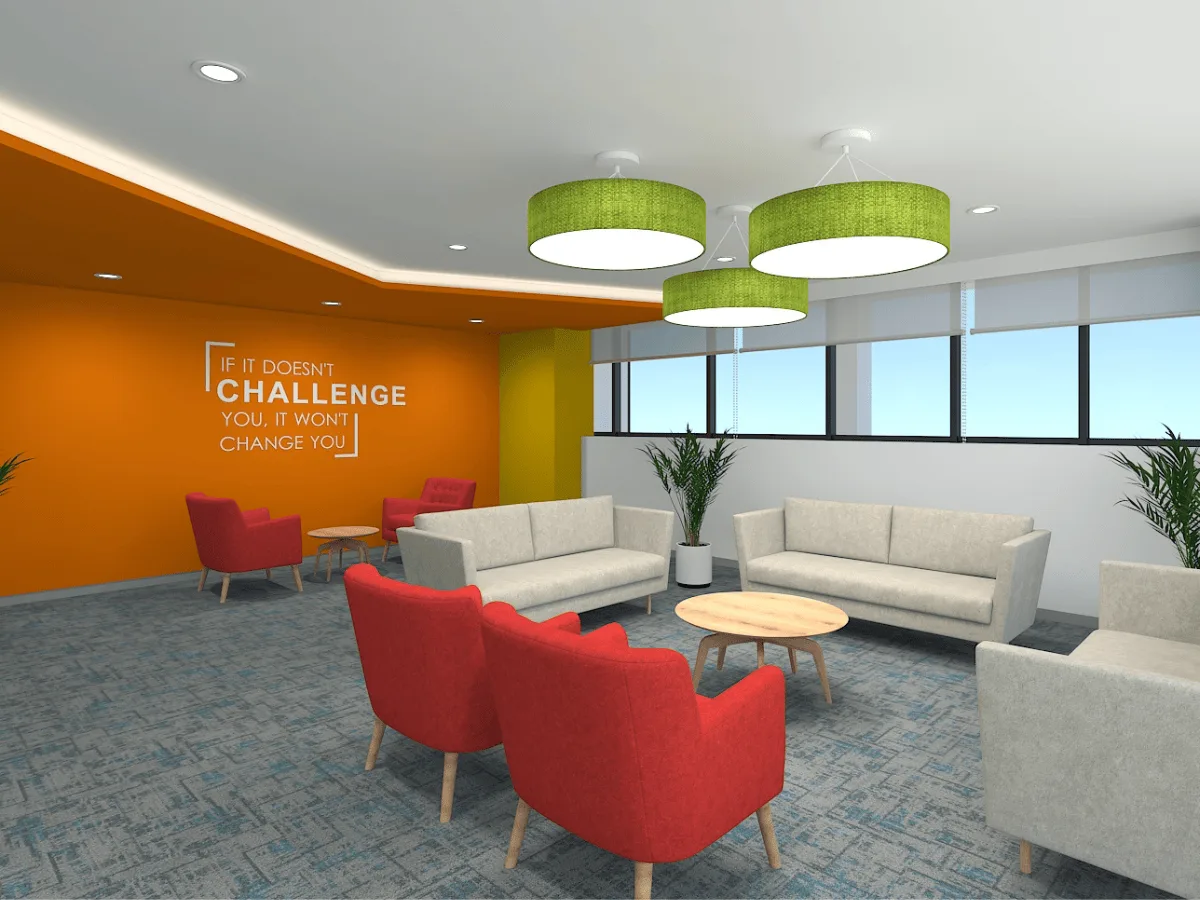 Breakout lounge with orange accent wall, red armchairs, and green pendant lights