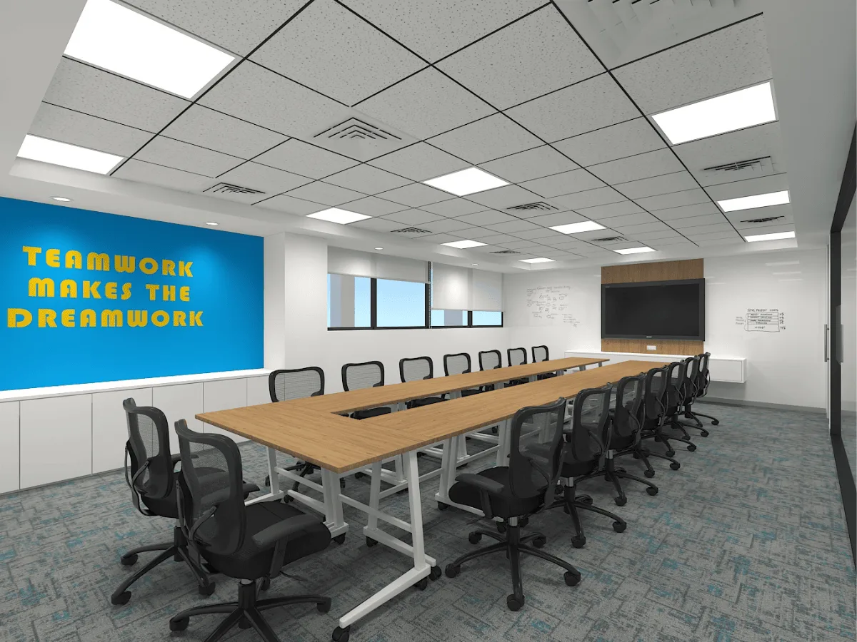 Large conference room with U-shaped table, whiteboard walls, and motivational graphics