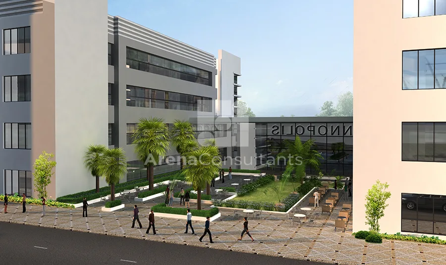 Landscaped courtyard between research buildings with seating areas, palm trees, and walkways