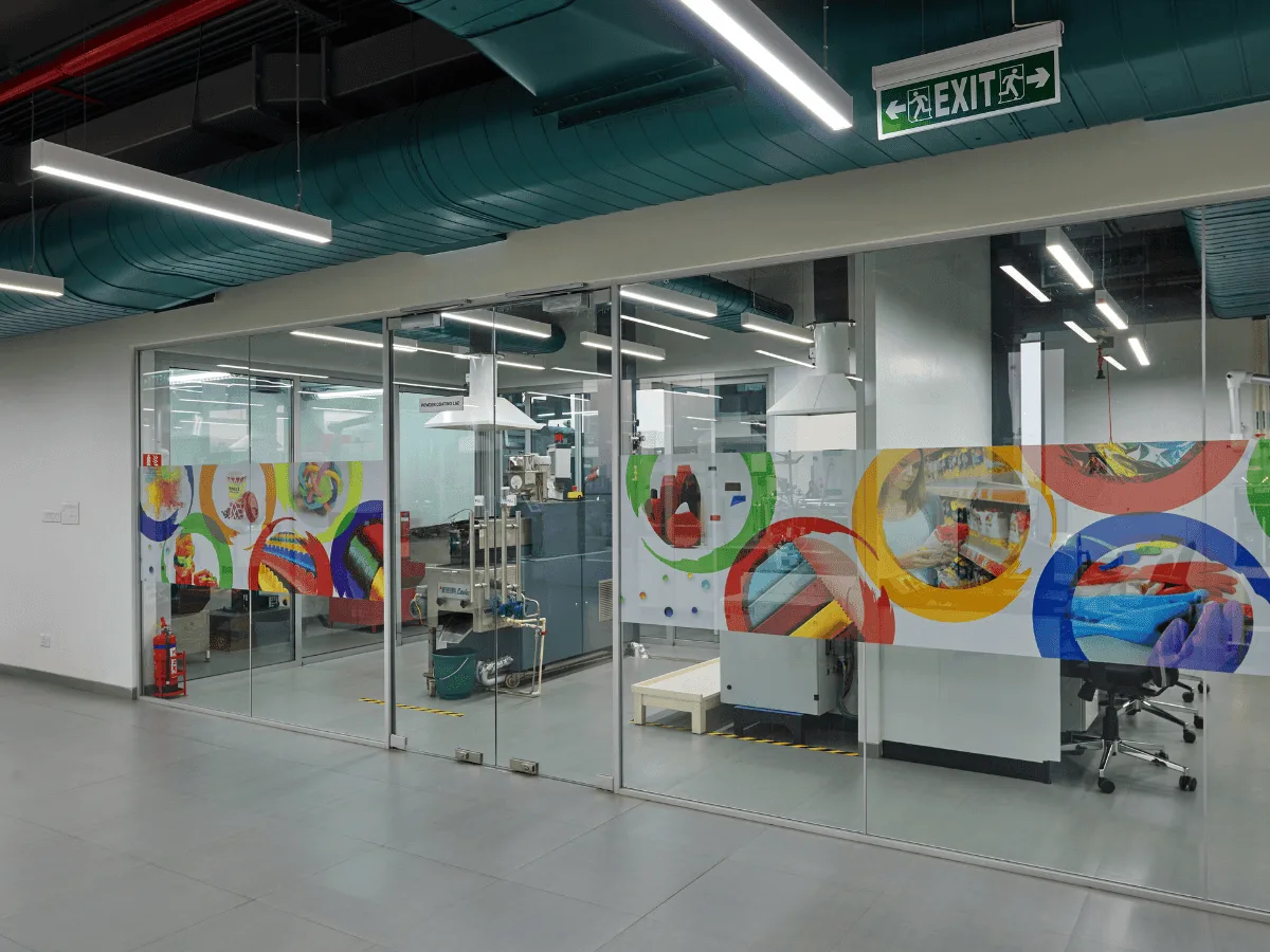 Glass partitions with branded art graphics at office-lab entrance
