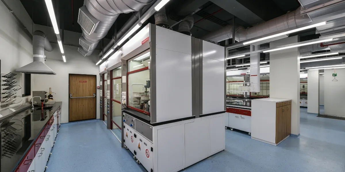 Modern laboratory with fume hoods, safety shower and clear circulation