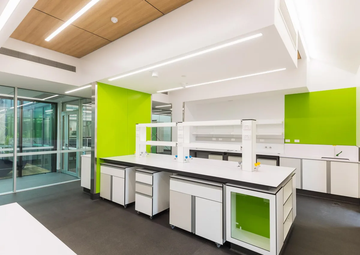 Laboratory with green accent walls and cabinet panels against a white base